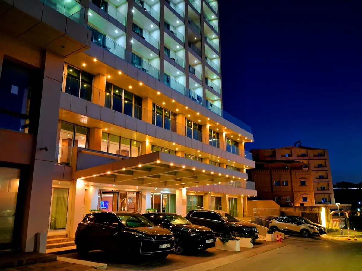 A lit hotel entrance and lobby at night