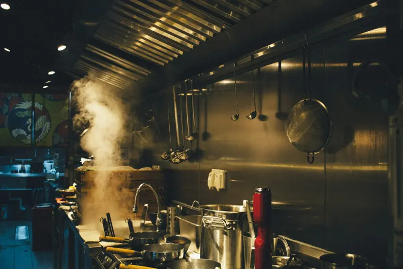 Cooks at work in a busy commercial restaurant kitchen