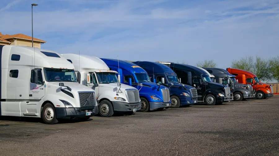 A row of fleet trucks parked at a logistics yard